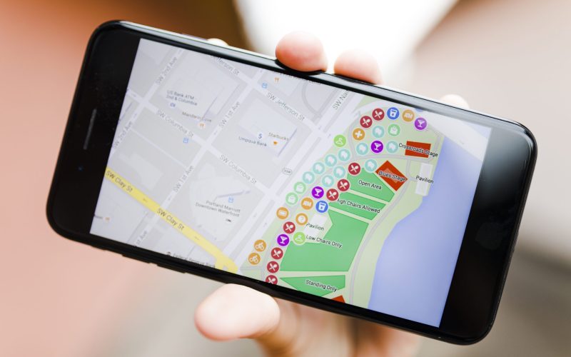 close-up-person-s-hand-holding-smartphone-with-map-gps-navigation